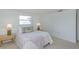 Bright bedroom featuring a cozy bed with beach-themed pillows and decor at 9205 Ledgestone Ln, Port Richey, FL 34668