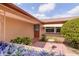 Inviting front entrance with brick walkway, lush landscaping, and decorative touches for a warm welcome at 9205 Ledgestone Ln, Port Richey, FL 34668