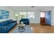 Comfortable living room with large windows, hardwood floors, and a welcoming ambiance at 9205 Ledgestone Ln, Port Richey, FL 34668