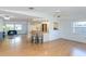 Open floor plan showcasing the living room with ceiling fan and adjacent kitchen with breakfast bar at 9205 Ledgestone Ln, Port Richey, FL 34668