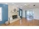 Spacious living room with fireplace and access to the sunroom through sliding glass doors at 9205 Ledgestone Ln, Port Richey, FL 34668