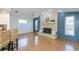 Inviting living room featuring a brick fireplace, ceiling fan, and an abundance of natural light at 9205 Ledgestone Ln, Port Richey, FL 34668