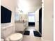 Clean and modern bathroom featuring a white vanity, a toilet, and a granite countertop at 9650 Lake Chase Island Way # 9650, Tampa, FL 33626