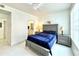 Stylish bedroom featuring a grey bed frame, modern furnishings, and natural light at 9650 Lake Chase Island Way # 9650, Tampa, FL 33626