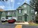 Charming townhome with green exterior, well-maintained landscaping, and private parking spaces at 9650 Lake Chase Island Way # 9650, Tampa, FL 33626