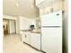 Open concept kitchen with white appliances, granite countertops, and seamless flow to the living area at 9650 Lake Chase Island Way # 9650, Tampa, FL 33626