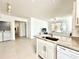 Bright, open-concept kitchen with granite countertops and stainless-steel appliances and view to living room at 9650 Lake Chase Island Way # 9650, Tampa, FL 33626