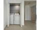 Convenient laundry room with modern washer and dryer units, optimizing space and functionality at 9650 Lake Chase Island Way # 9650, Tampa, FL 33626