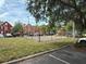 Community playground for with swings and a play structure surrounded by green space at 9650 Lake Chase Island Way # 9650, Tampa, FL 33626