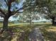 Community tennis court surrounded by trees offering a private and serene playing environment at 9650 Lake Chase Island Way # 9650, Tampa, FL 33626
