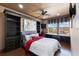 Comfortable bedroom with built-in shelving, desk area, and bright windows offering scenic views at 107 Athenian Way, Tarpon Springs, FL 34689