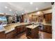 Gourmet kitchen features an island with a wine rack, stainless steel appliances, and wood cabinets at 107 Athenian Way, Tarpon Springs, FL 34689