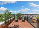 Inviting roof deck with lounge chairs and potted plants offering a relaxing outdoor space at 107 Athenian Way, Tarpon Springs, FL 34689