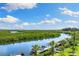 Beautiful waterfront view showcasing the serene river and tropical landscaping at 107 Athenian Way, Tarpon Springs, FL 34689