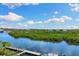 Scenic waterfront view overlooking the river, mangroves, and the neighborhood beyond at 107 Athenian Way, Tarpon Springs, FL 34689