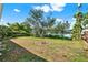 Backyard with mature trees and view of the lake at 10828 99Th Pl, Seminole, FL 33772