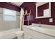 Bathroom with a tub-shower combo, vanity with a white marble countertop and wooden shelving at 10828 99Th Pl, Seminole, FL 33772