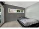 Minimalist bedroom with a sleek platform bed, a modern design, and natural light streaming through the windows at 10828 99Th Pl, Seminole, FL 33772