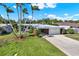 Well-maintained single-story home featuring a tidy front yard and mature landscaping at 10828 99Th Pl, Seminole, FL 33772