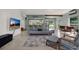 Inviting living room featuring a modern sofa, stylish decor, and an open layout leading to the kitchen at 10828 99Th Pl, Seminole, FL 33772