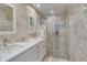 The primary bathroom has a dual sink vanity with tile backsplash and glass shower at 1104 Northridge Dr, Palm Harbor, FL 34683