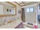 Bathroom featuring decorative wall paper, a gold-trimmed mirror, and a shower-tub combination at 1104 Northridge Dr, Palm Harbor, FL 34683