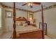 Traditional style bedroom with a four-poster bed, ceiling fan, and decorative wall trim at 1104 Northridge Dr, Palm Harbor, FL 34683