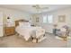 This is a bright bedroom with white walls and carpet, a large bed, and a ceiling fan at 1104 Northridge Dr, Palm Harbor, FL 34683
