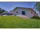 Exterior side of house with pool and green lawn at 1104 Northridge Dr, Palm Harbor, FL 34683