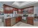 Updated kitchen with stainless steel appliances, granite countertops, and custom cabinetry at 1104 Northridge Dr, Palm Harbor, FL 34683