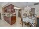 Open-concept kitchen features custom wood cabinets, granite countertops, and stainless steel appliances at 1104 Northridge Dr, Palm Harbor, FL 34683