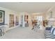 Open-concept living area with French doors, decorative decor, and stylish furnishings, leading to a dining space at 1104 Northridge Dr, Palm Harbor, FL 34683