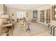 Stylish living room featuring French doors, decorative chairs, black and white accents, and natural light at 1104 Northridge Dr, Palm Harbor, FL 34683