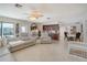 Spacious living room with tile flooring, neutral tones, and seamless flow to adjacent rooms at 1104 Northridge Dr, Palm Harbor, FL 34683