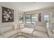 Bright living room featuring a sectional sofa, decorative art, and a window view of the pool area at 1104 Northridge Dr, Palm Harbor, FL 34683
