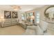 This stylish living room features an L-shaped sofa, modern lighting, and access to the outdoor pool area at 1104 Northridge Dr, Palm Harbor, FL 34683