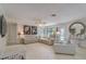 Bright living room featuring tile floors, neutral walls, modern furniture and decor, and doors leading to a private pool at 1104 Northridge Dr, Palm Harbor, FL 34683