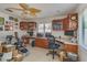 Bright office space with built-in desks, cabinets, and a leafy ceiling fan at 1104 Northridge Dr, Palm Harbor, FL 34683