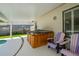 Covered patio area with a hot tub and seating at 1104 Northridge Dr, Palm Harbor, FL 34683