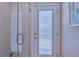 Modern shower featuring glass doors, tan tile and gold hardware at 1104 Northridge Dr, Palm Harbor, FL 34683