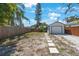 Backyard with a detached garage, a wood fence and a stone walkway at 1110 36Th N Ave, St Petersburg, FL 33704