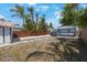 A spacious backyard with a wooden fence, stepping stones, and lush palm trees, perfect for outdoor activities and privacy at 1110 36Th N Ave, St Petersburg, FL 33704