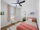 Bright bedroom with a ceiling fan, colorful patterned curtains, and stylish decor at 1110 36Th N Ave, St Petersburg, FL 33704