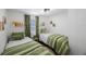 Comfortable bedroom with two twin beds, green bedding and matching curtains at 1110 36Th N Ave, St Petersburg, FL 33704