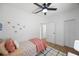 Light-filled bedroom featuring wood floors, a ceiling fan and a closet with louvered doors at 1110 36Th N Ave, St Petersburg, FL 33704