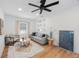 A cozy living area featuring a modern sofa, stylish decor, and hardwood floors for a welcoming ambiance at 1110 36Th N Ave, St Petersburg, FL 33704