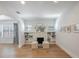 Bright and airy living room featuring hardwood floors, a charming fireplace, and stylish built-in shelving at 1110 36Th N Ave, St Petersburg, FL 33704