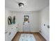 Mud room with white cabinets, wood-look tile floors and a door to the backyard at 1110 36Th N Ave, St Petersburg, FL 33704