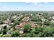 An aerial view displays community homes nestled among mature trees and natural landscaping with a tranquil pond at 11511 113Th St # 35E, Largo, FL 33778