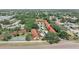 An aerial view displays the property with nearby tennis courts, mature trees, and lush green landscaping at 11511 113Th St # 35E, Largo, FL 33778